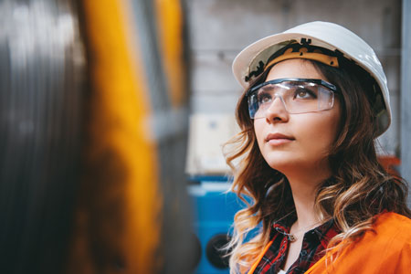 female manufactoring worker in protective gear