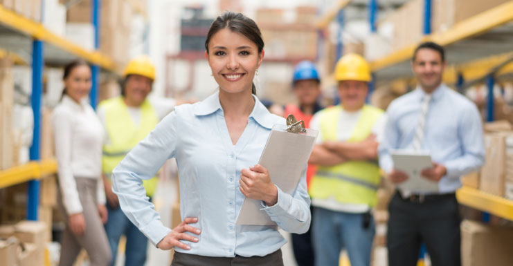 supply chain professional standing with clipboard