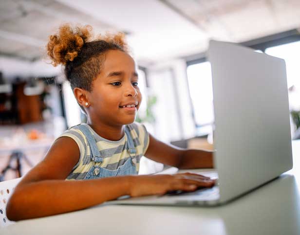 young learner at home on computer