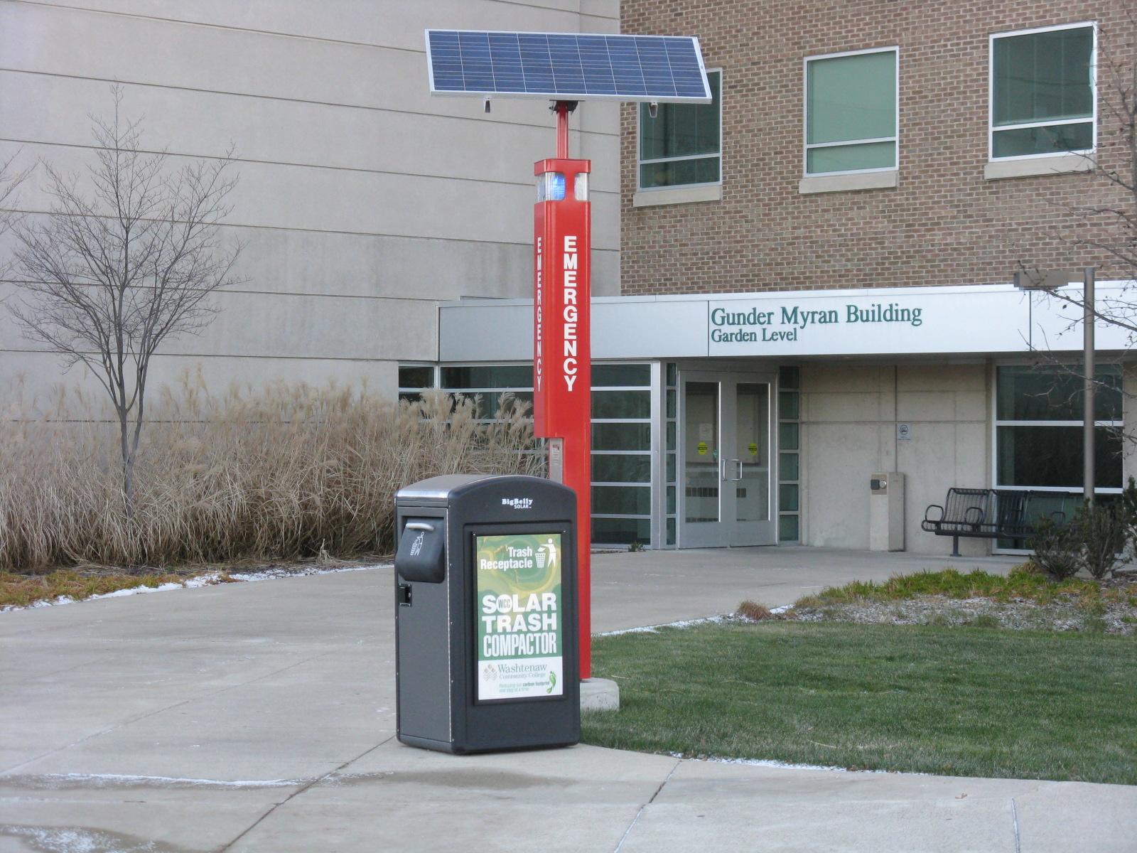 Solar powered emergency phone and trash compactor