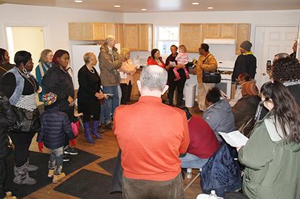 The Bond family addresses a house full of volunteers and supporters.