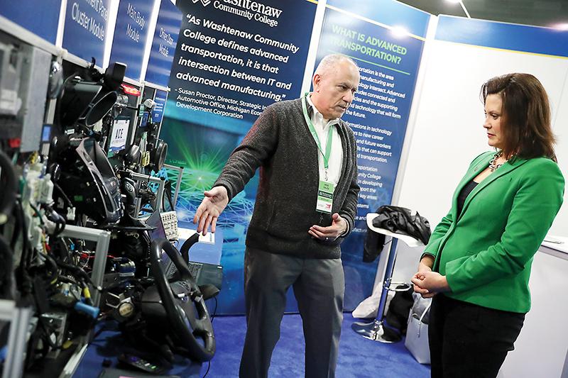 Michigan governor Gretchen Whitmer receives an overview of WCC’s new Automotive Cybersecurity Educator (ACE) from faculty member Mike Galea. | Photo by Kelly Gampel