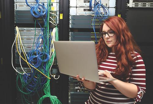 Female working on a computer in a computer server room