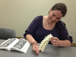 This is me, Erin Fedeson, with &quot;The Human Bone Manual&quot; open next to me as I apply one of the methods Dr. Barrett suggested: try to fit the vertebra together like a puzzle.