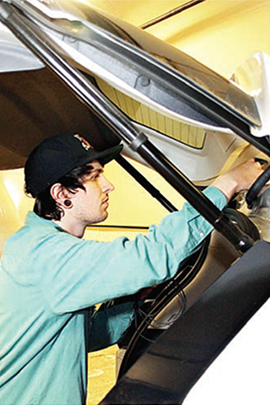 WCC student Calvin Tuttle installs Dedicated Short Range Communications technology into a car that is part of a U-M connected vehicle study. The college's involvement at the American Center for Mobility will allow WCC to continue developing and delivering mobility training for students.