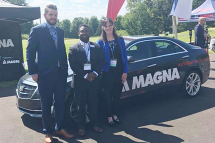 WCC students Jerry Allen (left) and Kali Welch (right) stand in front of a Level 3 autonomous vehicle with Dean of Advanced Technology and Public Service Careers Brandon Tucker during the Center for Automotive Research’s (CAR) Management Briefing Seminars.