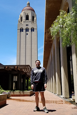 Matthew Burtell wears his WCC sweatshirt in front of Hoover Tower on the campus of Stanford University.