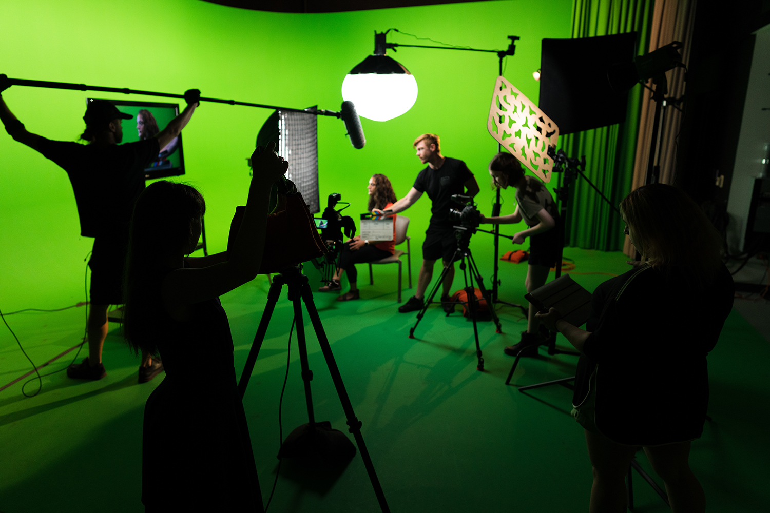 Students in greenscreen room