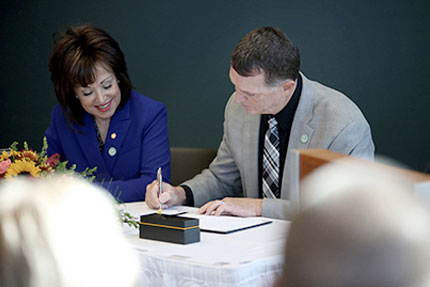 WCC President Dr. Rose B. Bellanca and Ironworkers Executive Director of Apprenticeship and Training Lee Worley sign a ceremonial contract at the college on Friday. The WCC-Ironworkers training partnership was extended by five years.