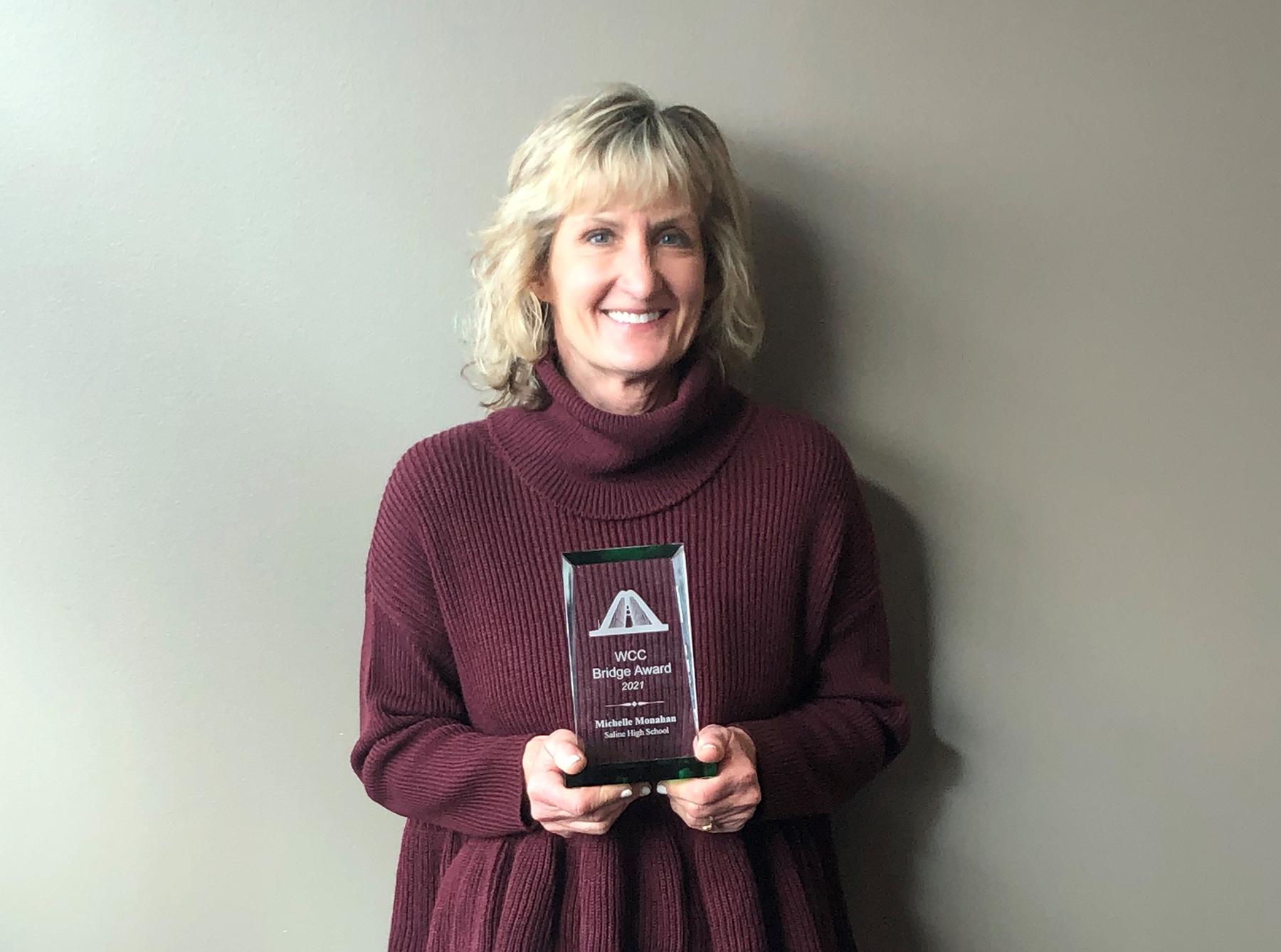 Michelle Monahan holding award