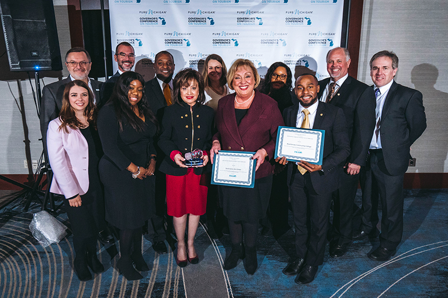 People posing with award