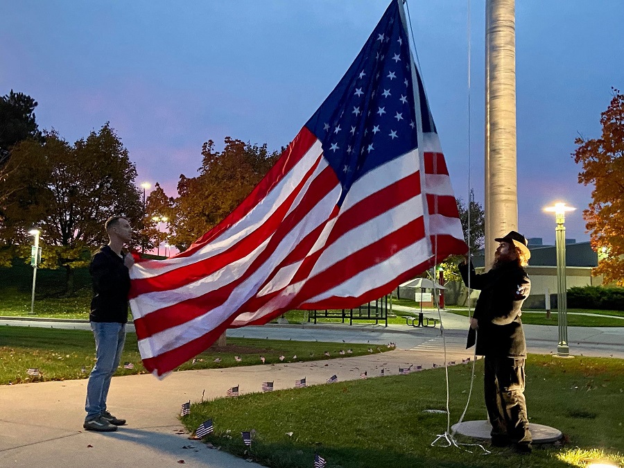 Raising flag at sunrise