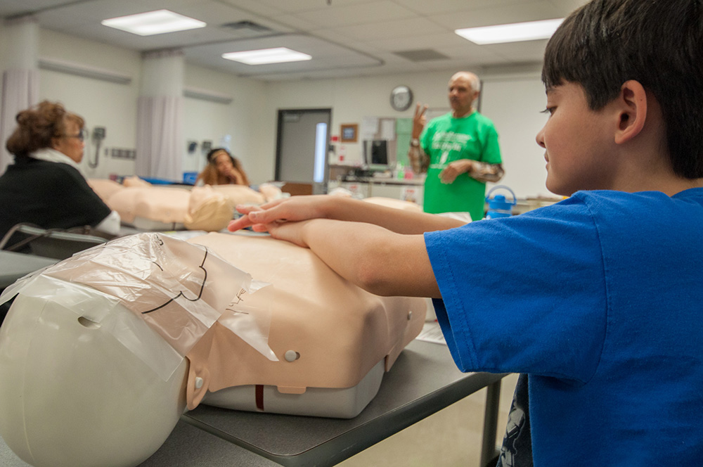 Matthew Goeloe practices his form while Hira Dedhia instructs the Adult CPR class at Free College Day. | Photo by Jessica Bibbee Matthew Goeloe practices his form while Hira Dedhia instructs the Adult CPR class at Free College Day. | Photo by Jessica Bibbee