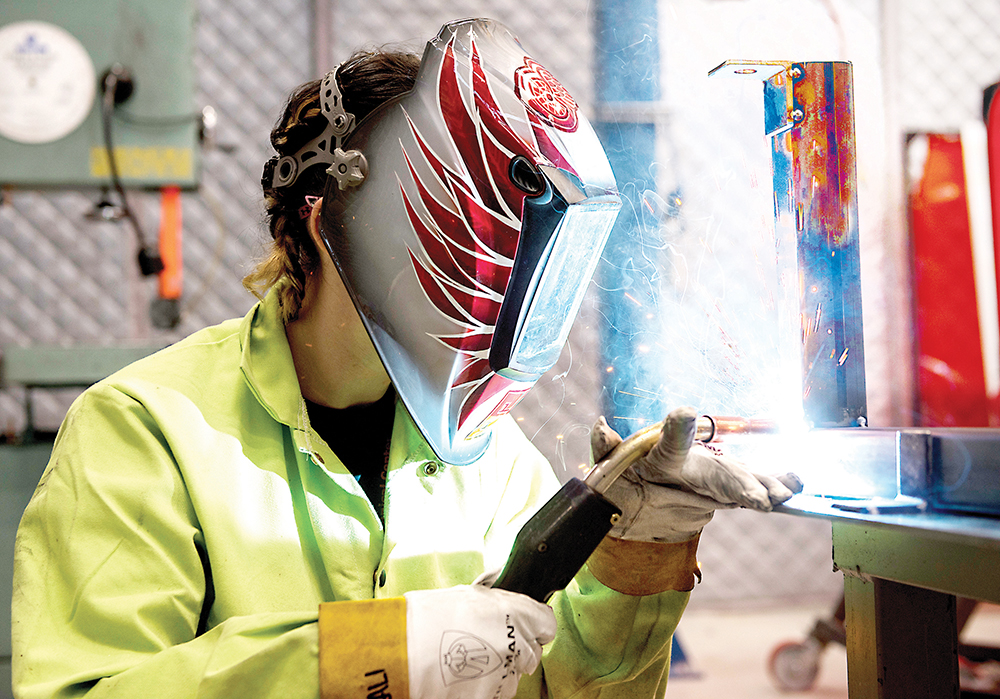 Washtenaw Community College student Kali Wealch hones her welding skills while working at the Toyota Research and Design facility in Saline. | Photo by Lon Horwedel