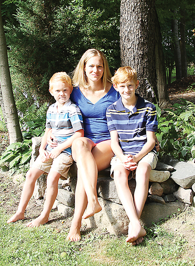 Laura Roughton with her sons Danny (left) and Isaac in the backyard of their Saline home. (Photo by Rich Rezler)