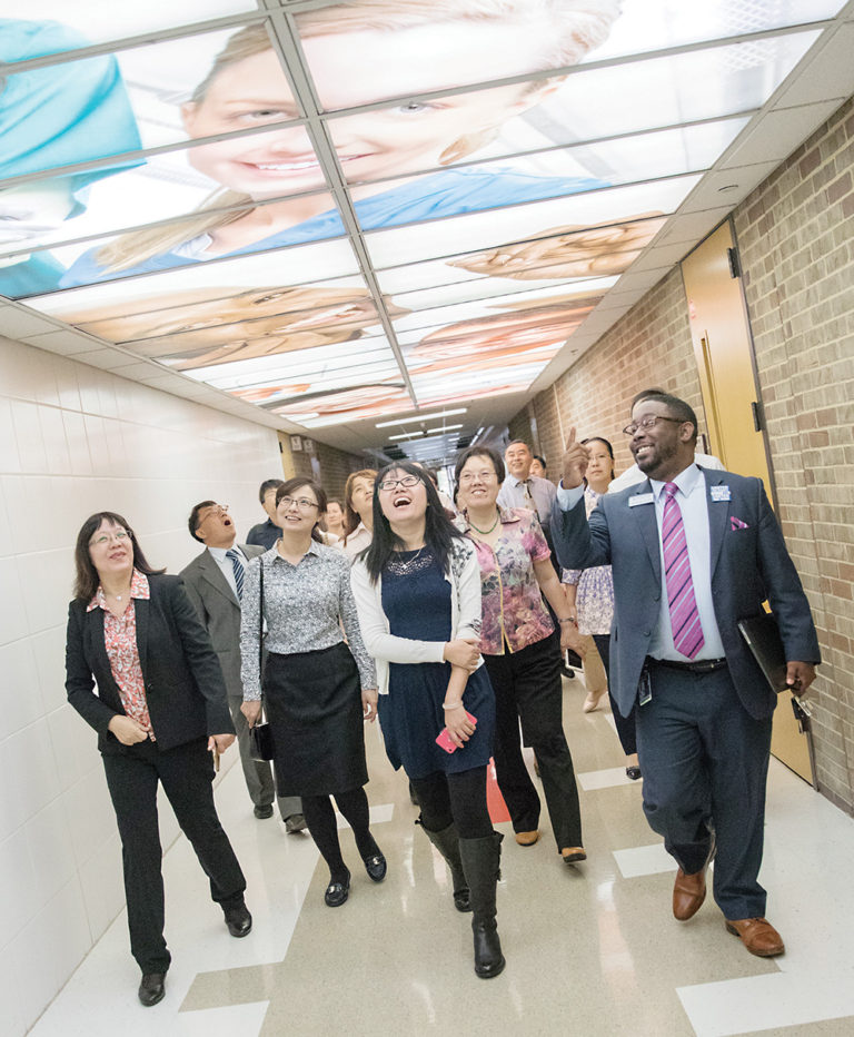 Brandon Tucker (right), WCC Dean of Advanced Manufacturing and Public Service Careers, leads a delegation of Chinese educators on a tour of the college’s Occupational Education Building. | PHOTO BY ANNE SAVAGE