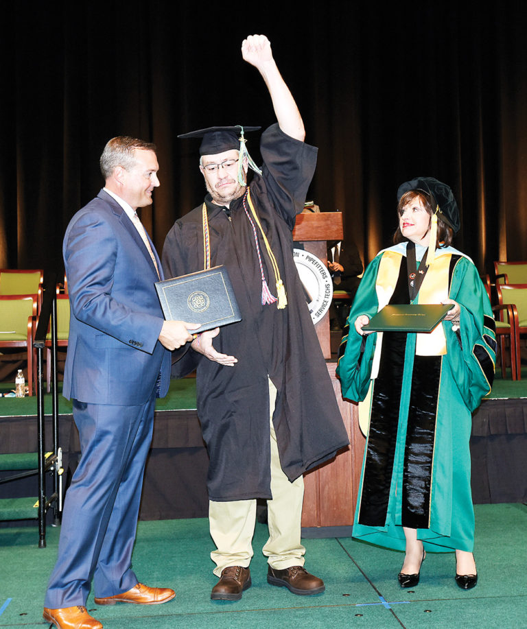 UA member Morey Cannady, from Local 208 in Denver, celebrates receiving his instructor certification from UA Director of Education and Training Chris Haslinger (left) and an associate degree from WCC President Dr. Rose B. Bellanca. | Photo by Lon Horwedel