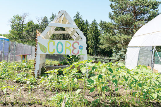 The on-campus Hoop House CORE Garden produces crops that are distributed on campus in the community. Plans call for traveling food carts to be placed in key low-income neighborhoods near the college. (Photo by CJ South)