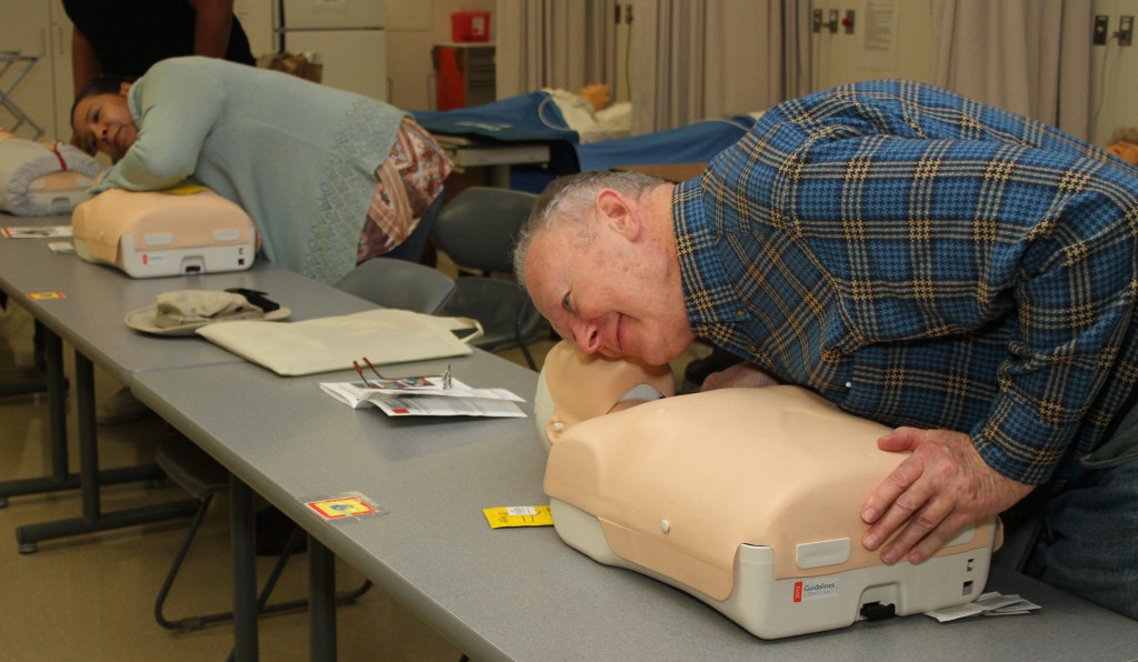 Community members participate in a CPR class during Free College Day on the campus of Washtenaw Community College on March 5. The class promoted the hands-only version of CPR that drops mouth-to-mouth breathing for 100 hard and fast chest compressions per minute – roughly matching the beat of the Bee Gees’ 1977 disco hit “Stayin’ Alive.”