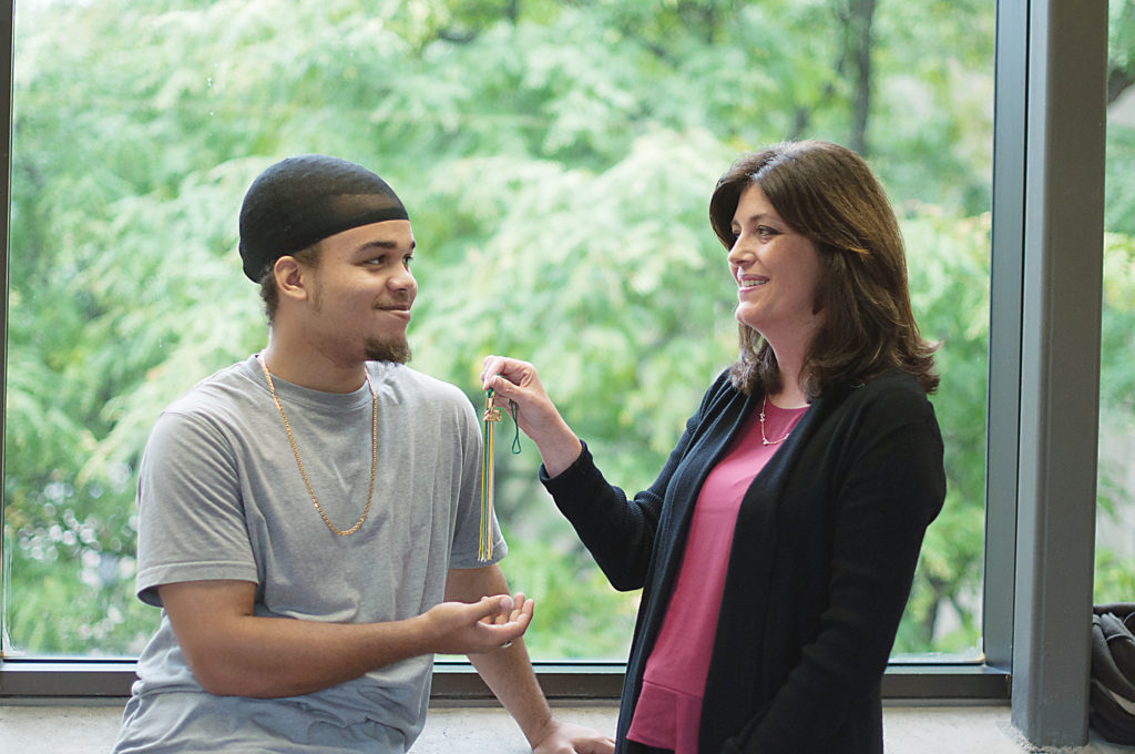 REACH Coordinator Kathy Stewart (right) and WCC student and REACH participant Indyo Anderson share a moment and examine his graduation tassle, which he earned through the Adult Transitions Program. (Photo by Jessica Bibbee) REACH Coordinator Kathy Stewart (right) and WCC student and REACH participant Indyo Anderson share a moment and examine his graduation tassle, which he earned through the Adult Transitions Program. (Photo by Jessica Bibbee)