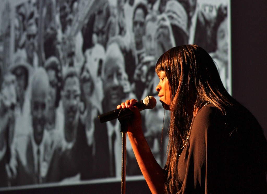 WCC English Instructor Dr. Kimberly Jones sings Sam Cooke’s “A Change Gonna Come” in front of a backdrop of photos documenting American civil rights history. Photo by Lynn Monson