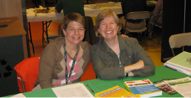 Geology instructor (L to R) Suzanne Albach and Biology instructor Dr. Emily Thompson share a smile at their Earth Day booth.