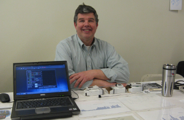 Energy and Systems Integration Manager Bill Ghrist demonstrates how new remote devices and software that monitors lighting, temperature and humidity are being used to reduce energy consumption on campus. Energy and Systems Integration Manager Bill Ghrist demonstrates how new remote devices and software that monitors lighting, temperature and humidity are being used to reduce energy consumption on campus.