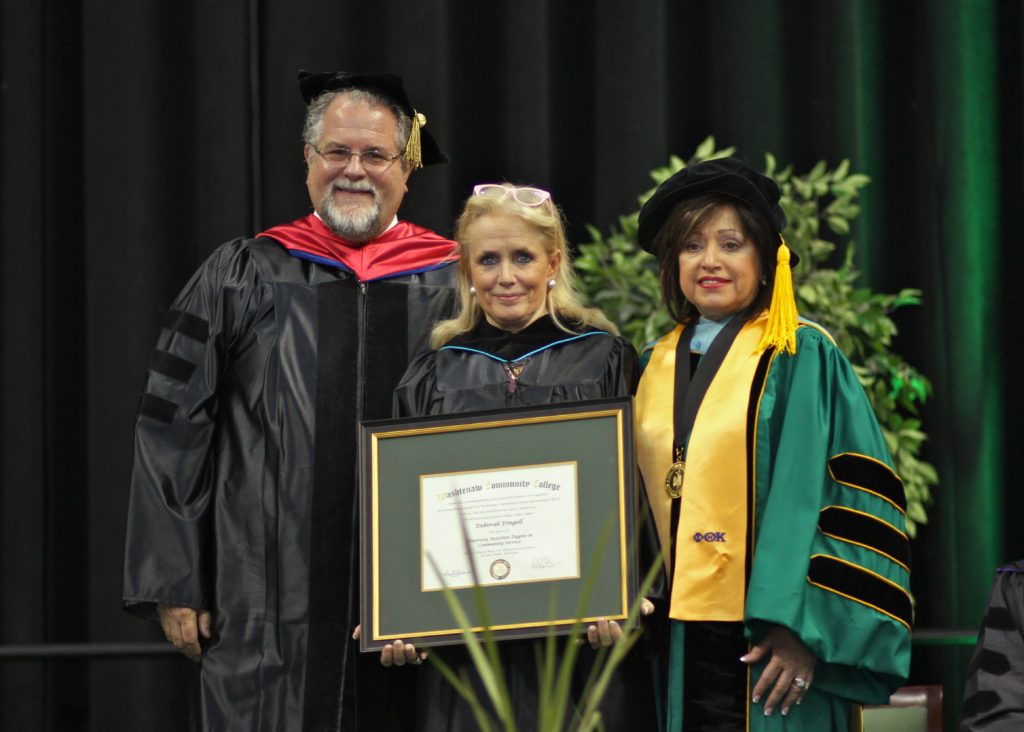 WCC Board of Trustees chairman Richard Landau, J.D., Ph.D. (left) and WCC President Dr. Rose B. Bellanca (right) present Congresswoman Debbie Dingell with her honorary degree. (Photo by Lynn Monson)