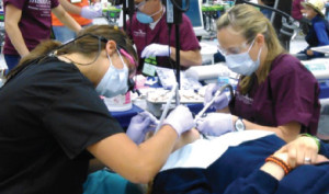 Jodi Neuman (right), WCC Clinical Instructor, volunteers her time at the Michigan Dental Association Mission of Mercy Event. Jodi Neuman (right), WCC Clinical Instructor, volunteers her time at the Michigan Dental Association Mission of Mercy Event.