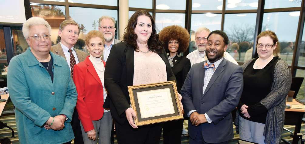 Emily Hatsigeorgiou (center) is honored at a recent WCC Board of Trustees meeting by Dean of Advanced Technologies & Public Service Careers Brandon Tucker (second from right) and WCC trustees (from left) Ruth A. Hatcher, Bill Milliken Jr., Diana McKnight-Morton, Richard J. Landau, J.D., Ph.D., Angela Davis, David DeVarti and Christina Fleming. (Photo by Lon Horwedel)