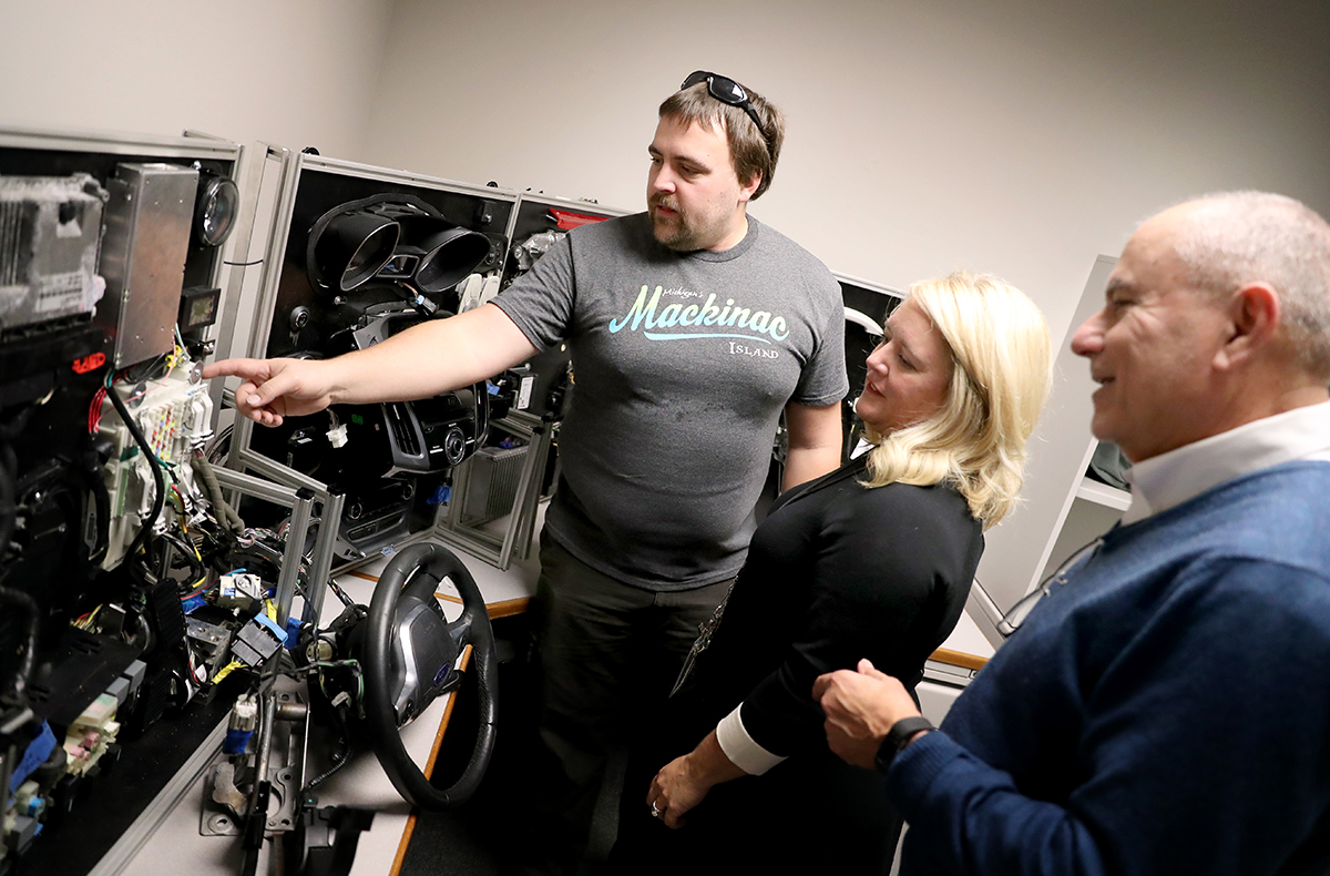Tim Brom of Grimm Cybersecurity explains how to set up WCC’s new mobile hacking workbench — which teaches students the mechanics of reverse engineering a vehicle – to faculty Cindy Krzeczkowski and Michael Galea. | Photo by Kelly Gampel