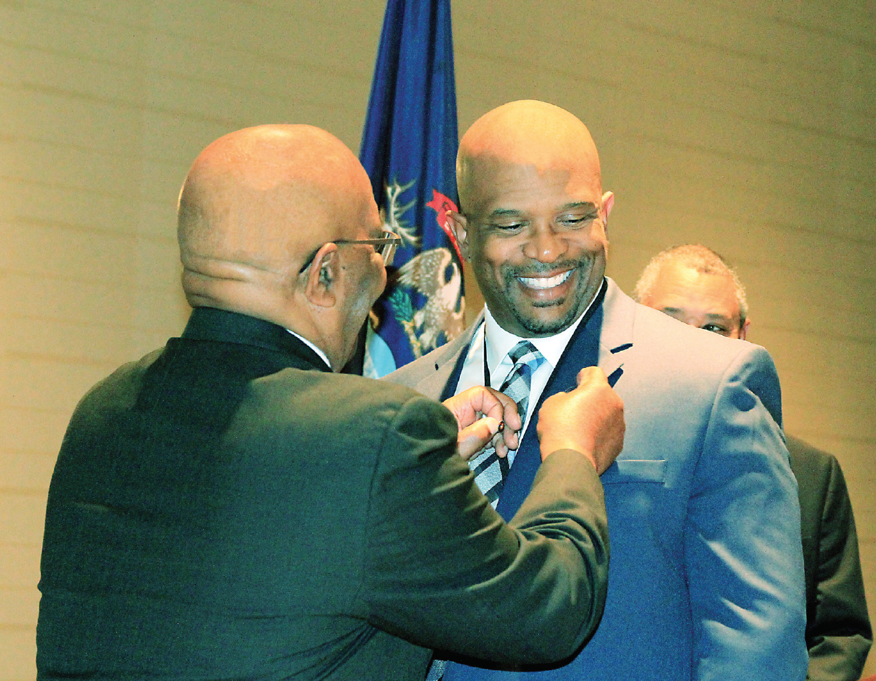 WCC Radiography program director and faculty member William Nelson (right) has a Technologist of the Year Award from the Michigan Society of Radiologic Technologists pinned to his lapel by his father, Robert Nelson. | . Photo courtesy of William Nelson