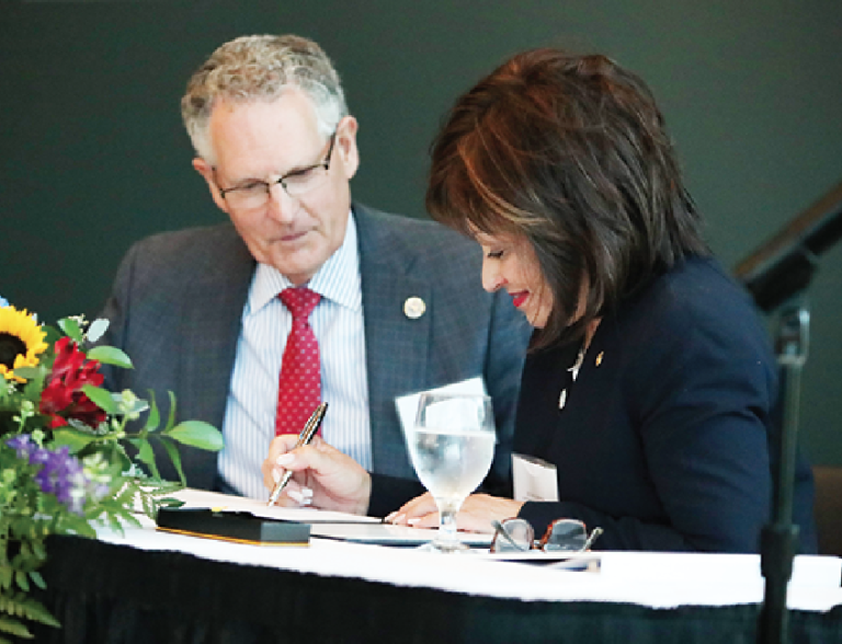 Roofers Union President Kinsey M. Robinson (left) and WCC President Dr. Rose B. Bellanca sign a contract signifying the union will hold its National Instructor Training Program on the college campus beginning in June 2020. (Photo by Kelly Gampel)