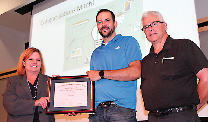 Mitch Smith (center) poses with WCC Dean of Apprenticeship & Skilled Trades Marilyn Donham and Milan Metal Systems’ Doug McCormick during a luncheon celebrating the completion of Smith’s apprenticeship. (Photo by Rich Rezler)