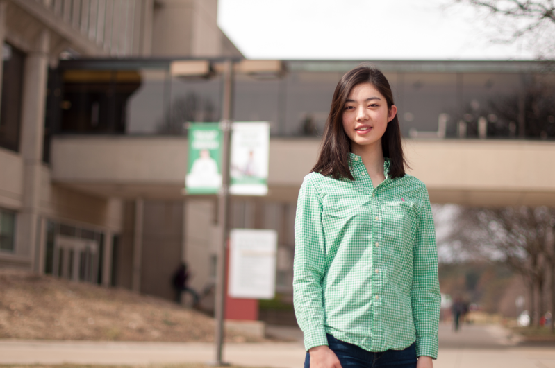 student standing outside on campus